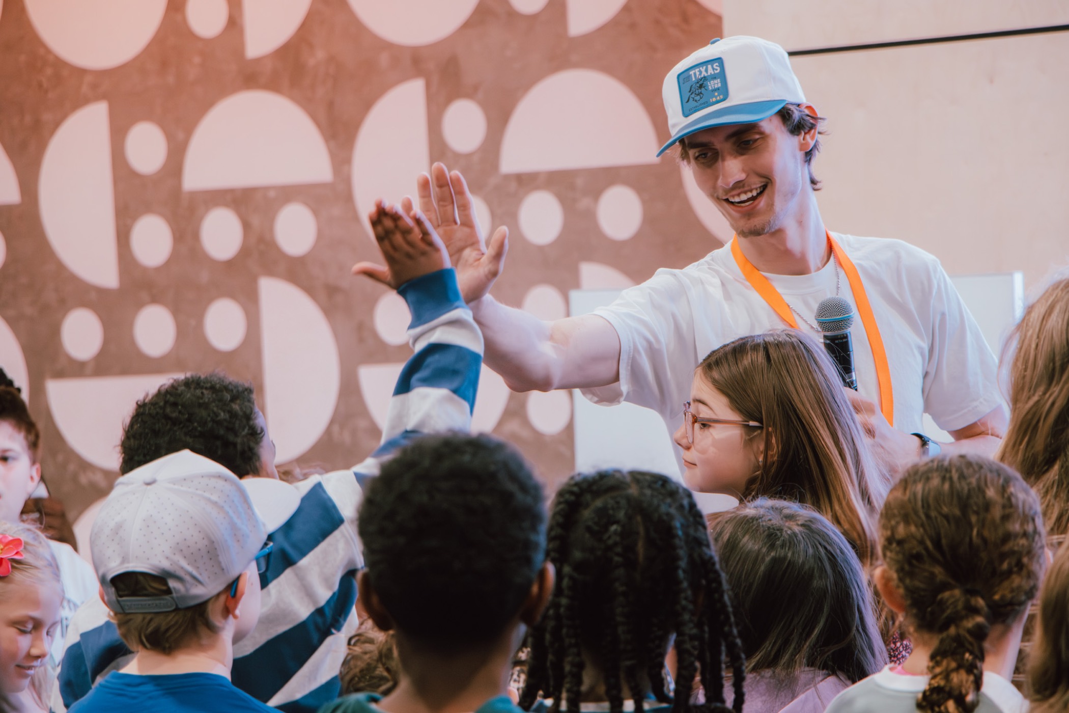 A leader high-fiving kids during Creative Church kids ministry
